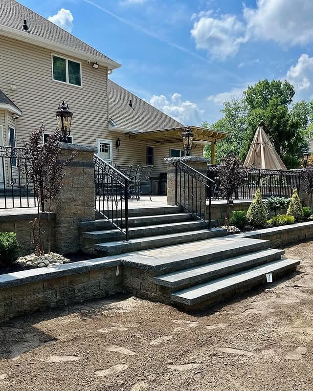 Paver steps and patio with a pergola, completed by Fernando Masonry in Manalapan, NJ